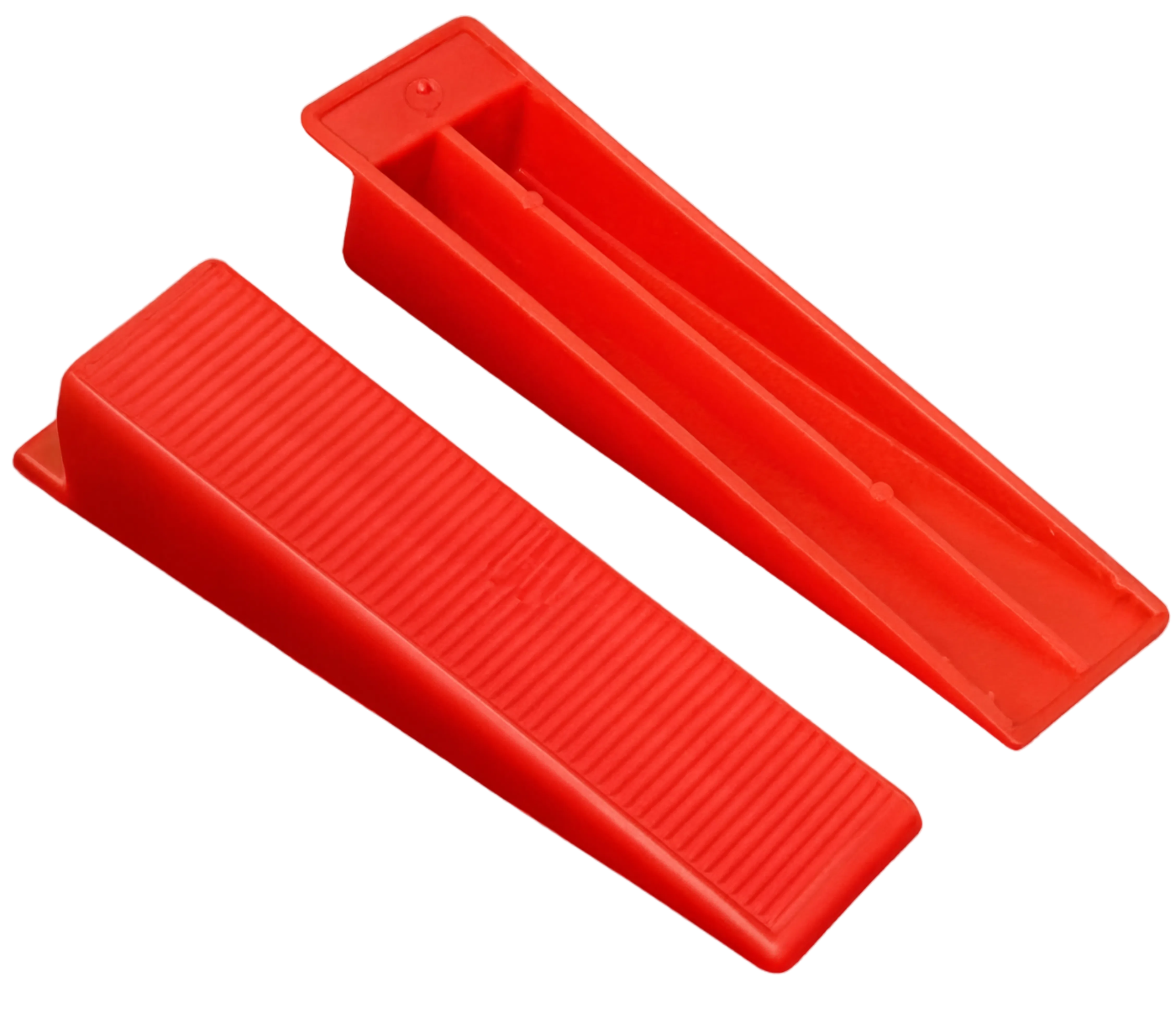 Two red reusable tile leveling wedges